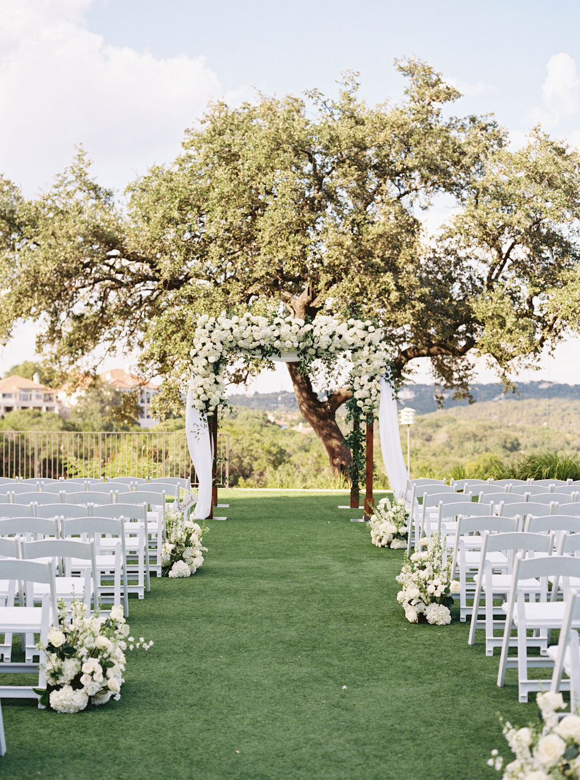 Omni Barton Creek Wedding ceremony on yard with lush white florals