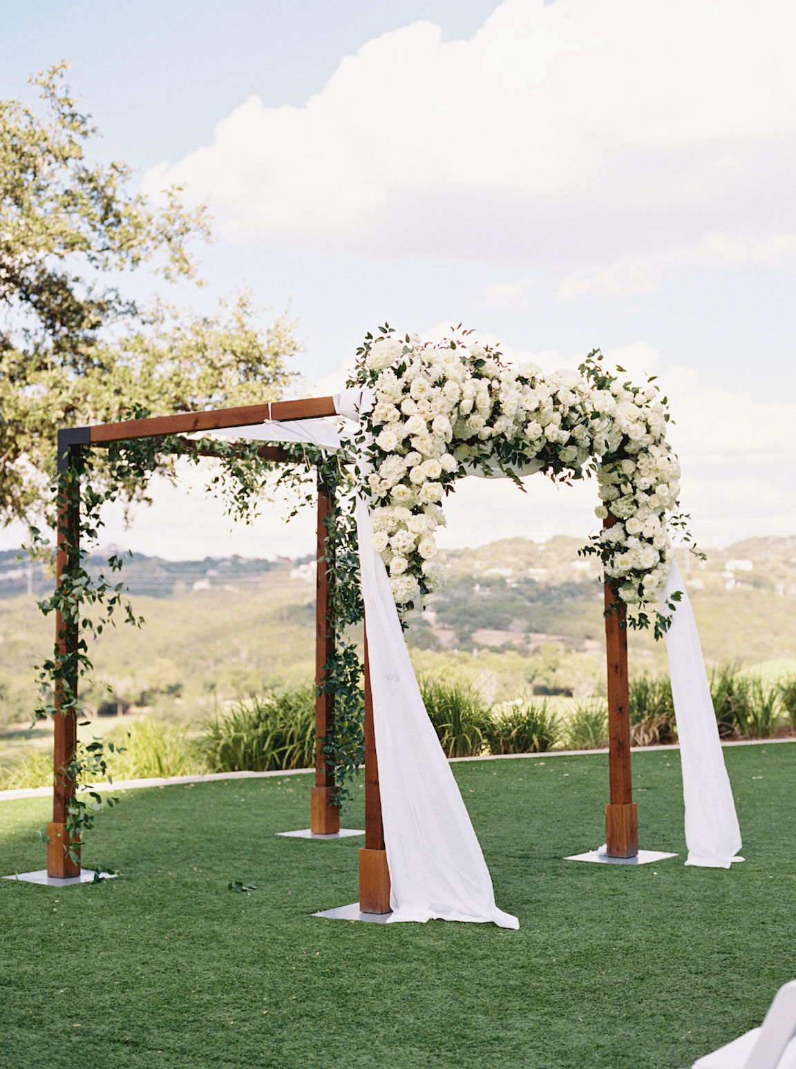Omni Barton Creek Wedding ceremony on yard with lush white florals