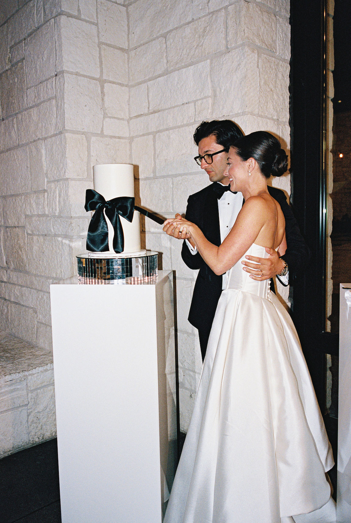 elegant Omni Barton Creek Wedding reception bride and groom cake cutting