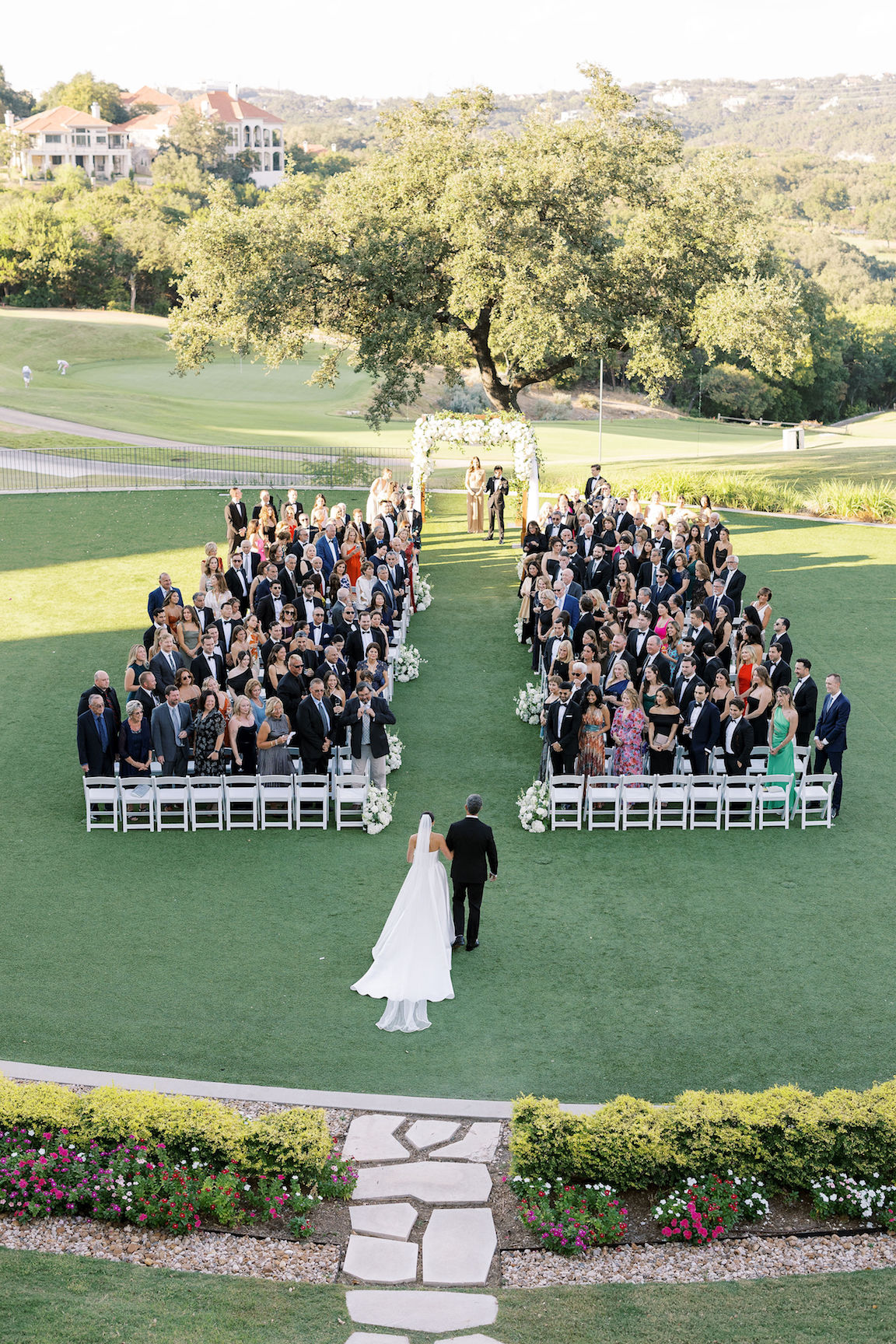 Omni Barton Creek Wedding ceremony on yard with lush white florals