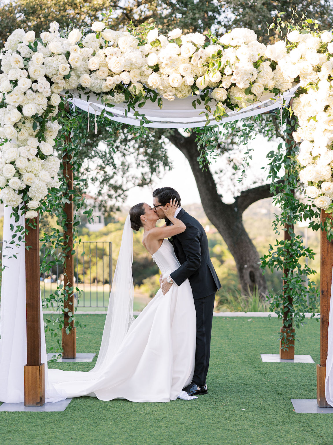 Omni Barton Creek Wedding ceremony on yard with lush white florals