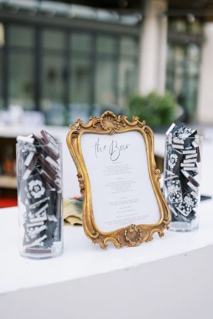 Lush black tie wedding reception at Omni Barton Creek with classic white florals and candlelit tables