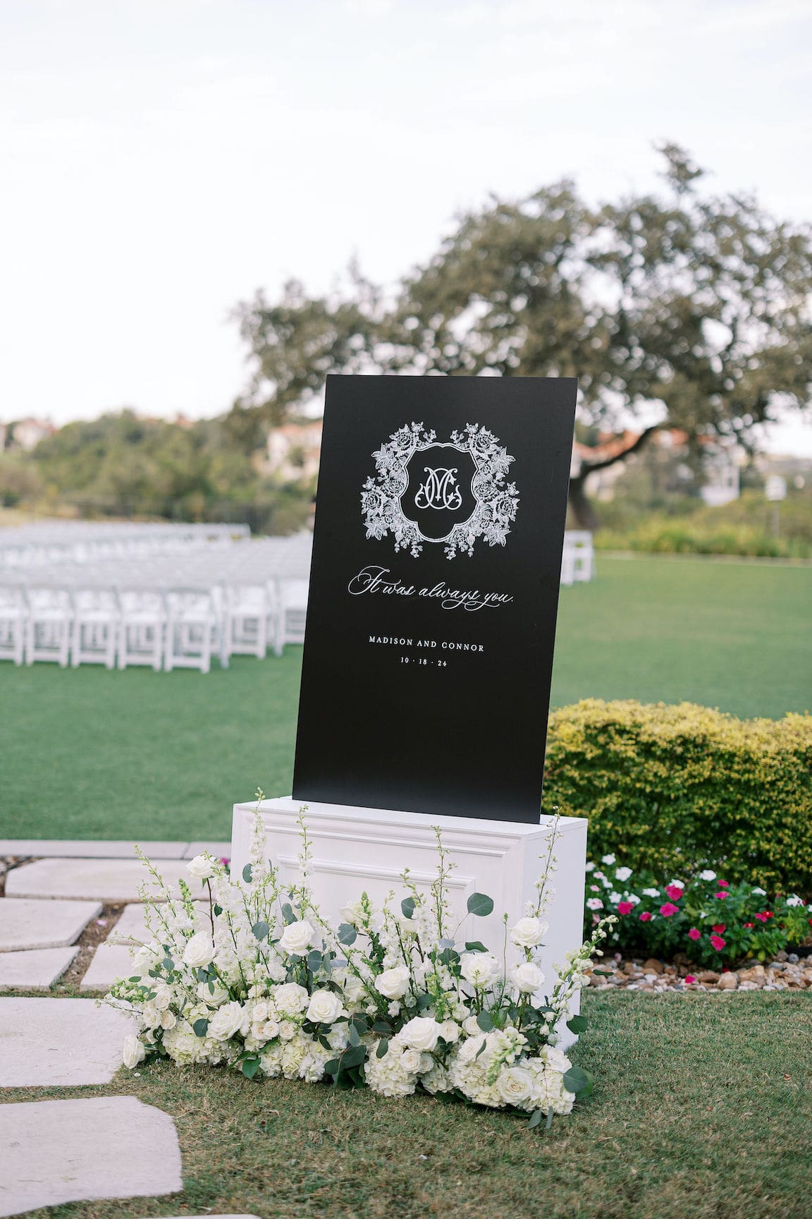 Elegant outdoor ceremony at Omni Barton Creek with white floral arrangements and Hill Country views