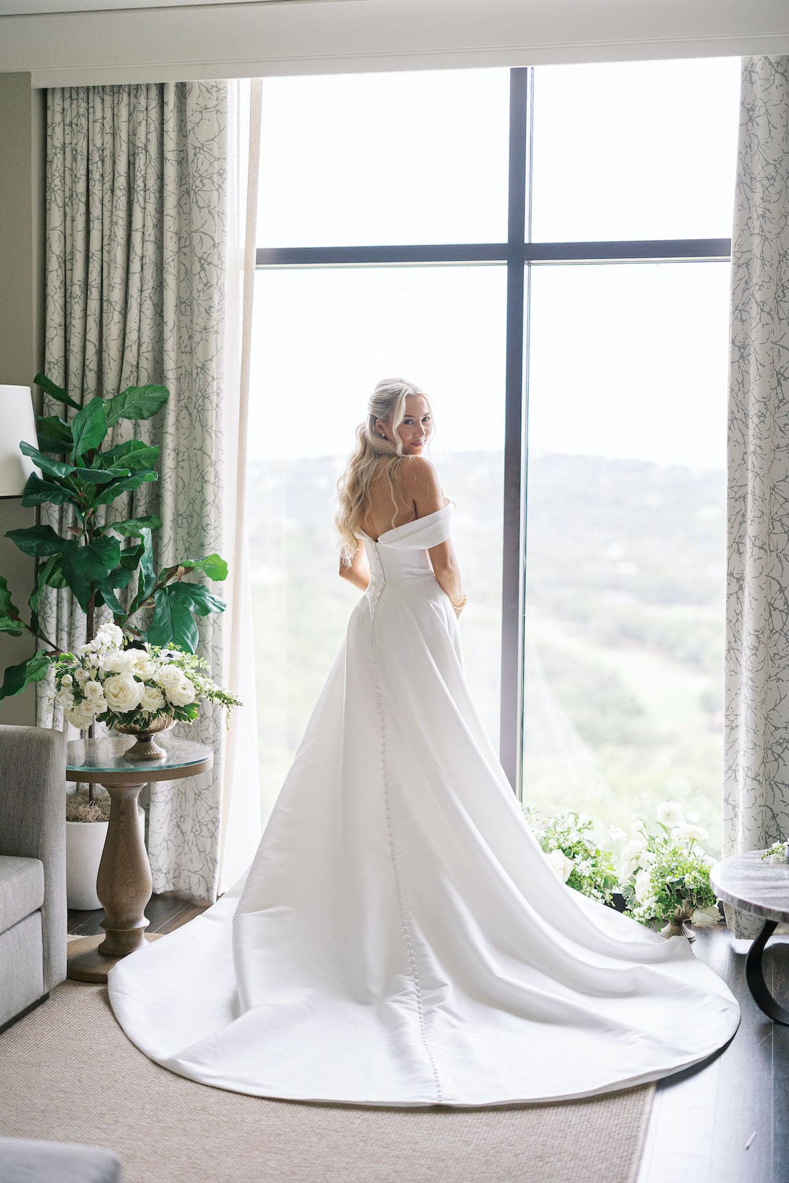 Bride getting ready in elegant suite at Omni Barton Creek, captured in timeless film wedding photography