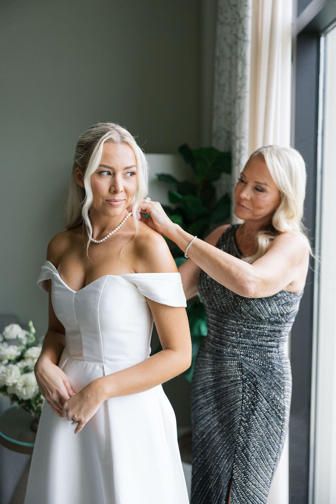 Bride getting ready in elegant suite at Omni Barton Creek, captured in timeless film wedding photography
