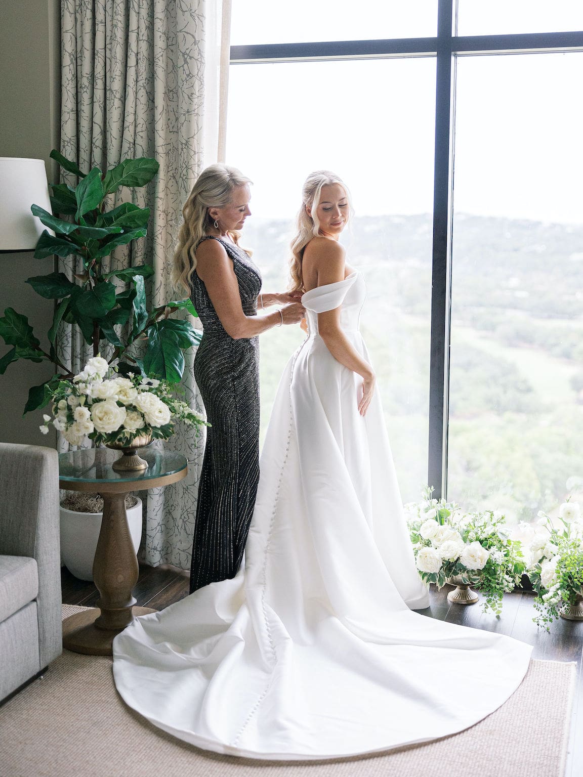 Bride getting ready in elegant suite at Omni Barton Creek, captured in timeless film wedding photography