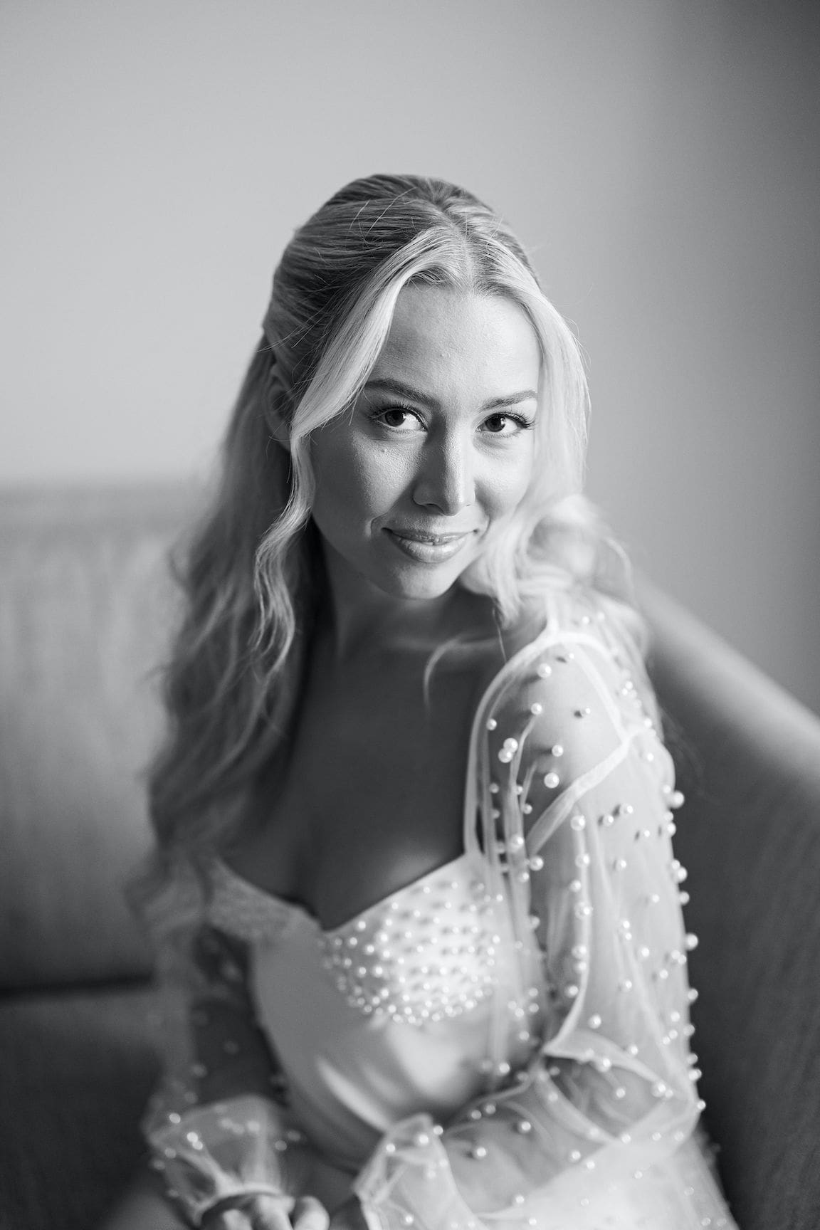 Bride getting ready in elegant suite at Omni Barton Creek, captured in timeless film wedding photography