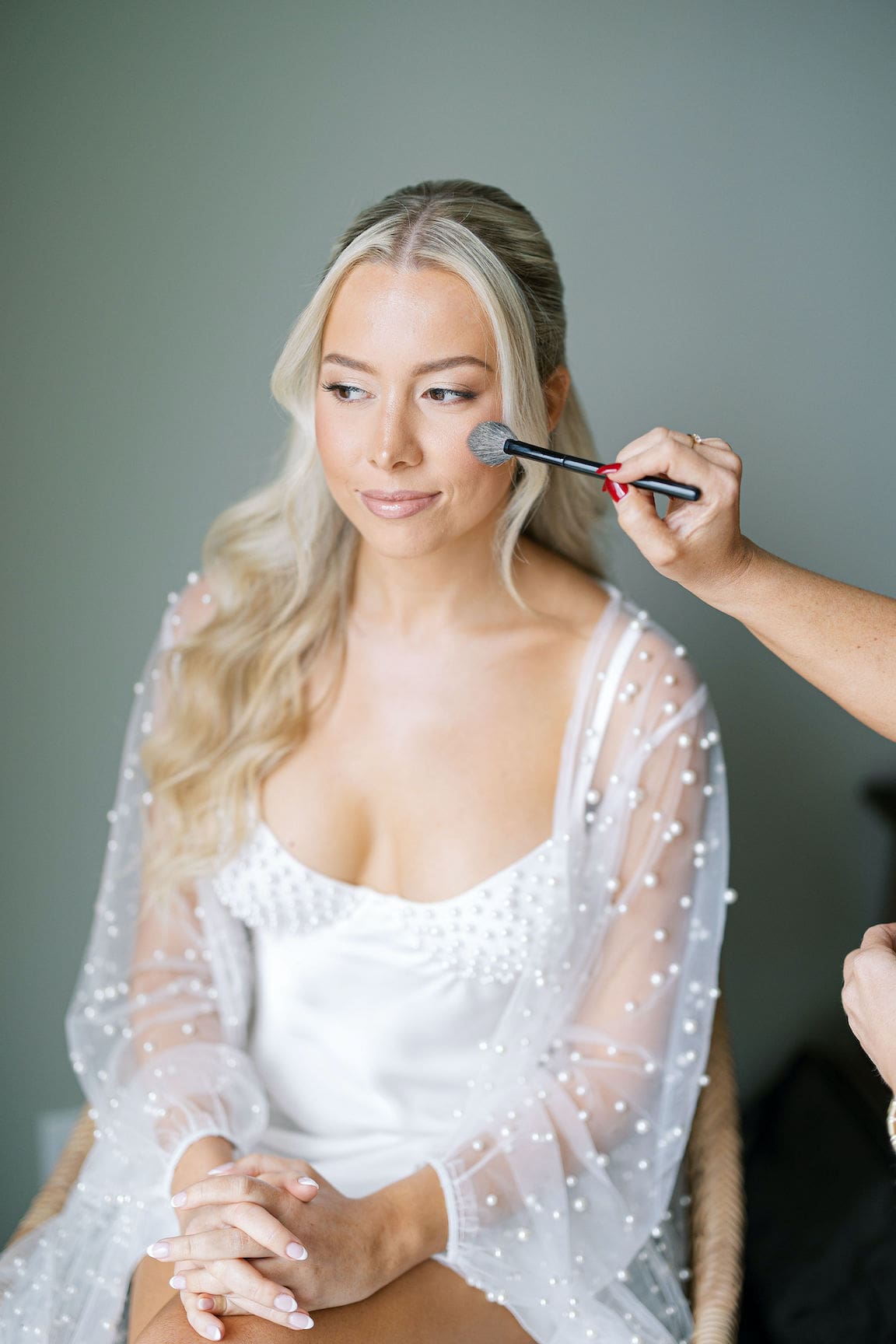 Bride getting ready in elegant suite at Omni Barton Creek, captured in timeless film wedding photography