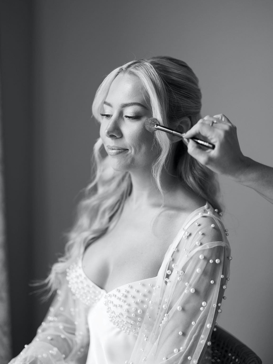 Bride getting ready in elegant suite at Omni Barton Creek, captured in timeless film wedding photography