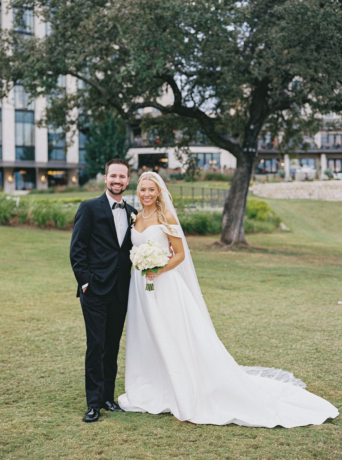 Elegant outdoor ceremony at Omni Barton Creek with white floral arrangements and Hill Country views