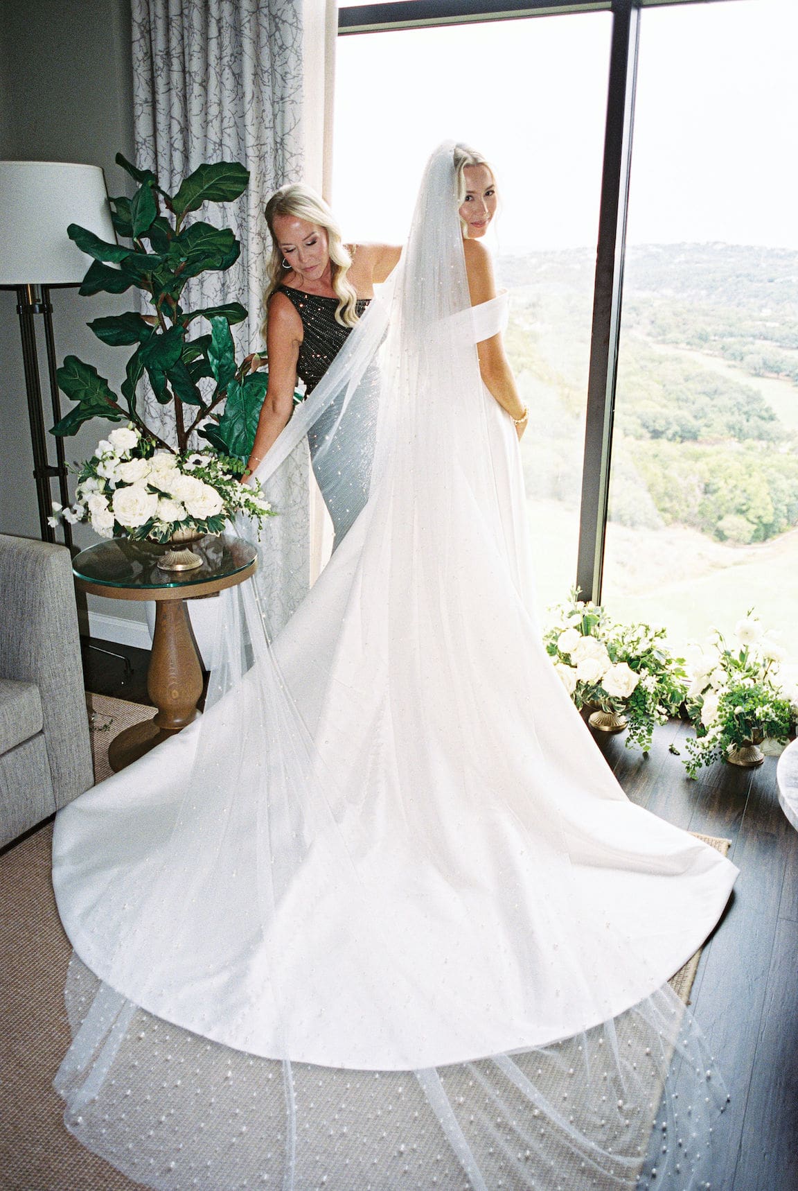 Bride getting ready in elegant suite at Omni Barton Creek, captured in timeless film wedding photography