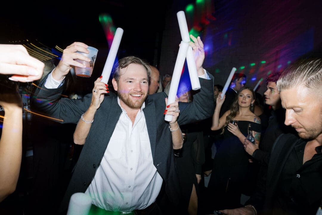 Packed dancefloor at Omni Barton Creek wedding with live band and joyful guests celebrating