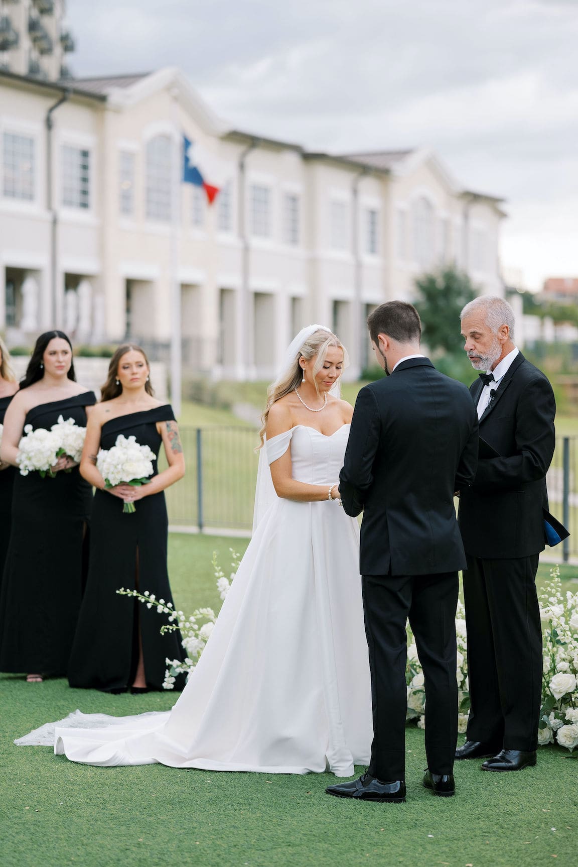 Elegant outdoor ceremony at Omni Barton Creek with white floral arrangements and Hill Country views