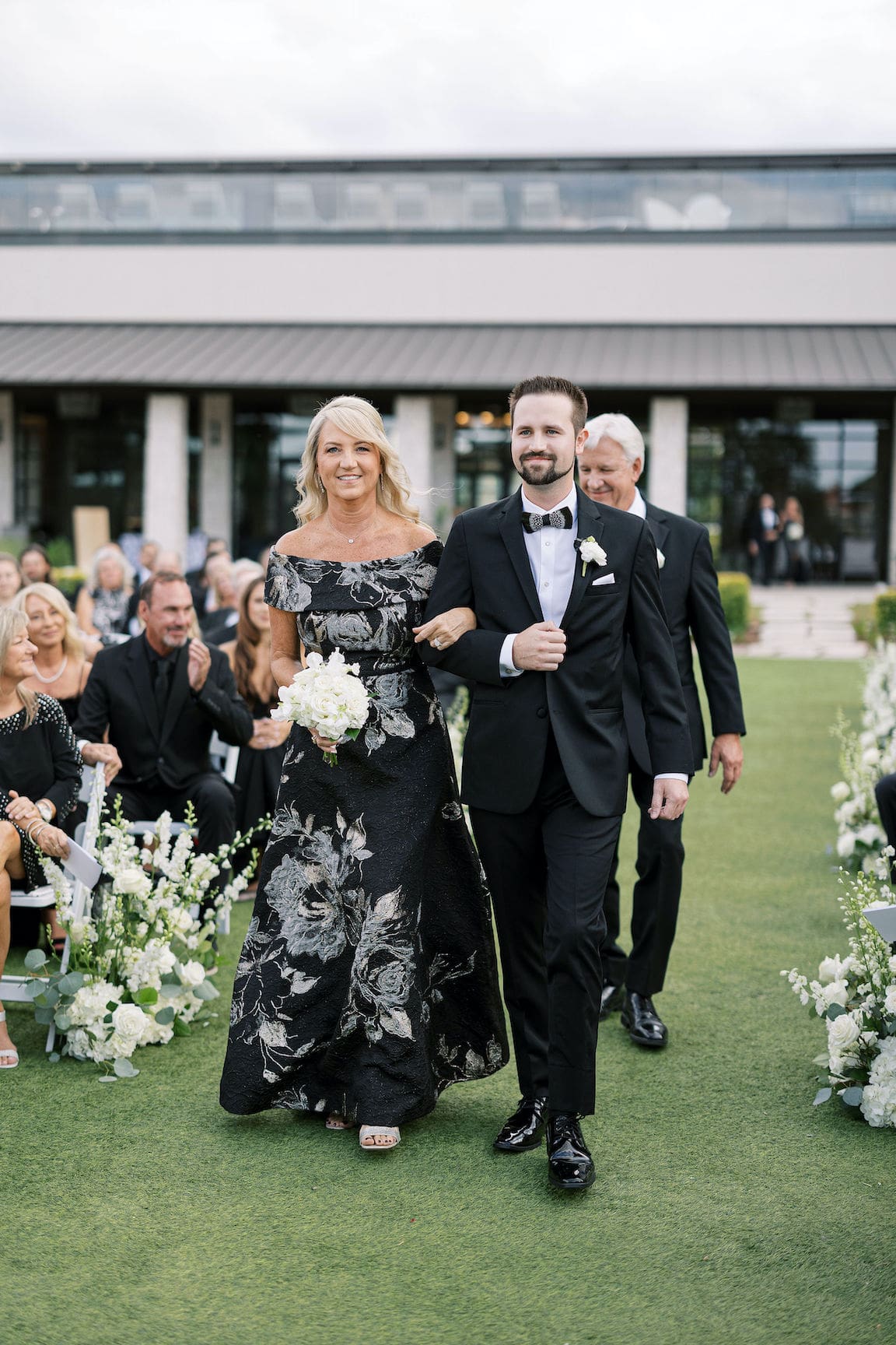 Elegant outdoor ceremony at Omni Barton Creek with white floral arrangements and Hill Country views