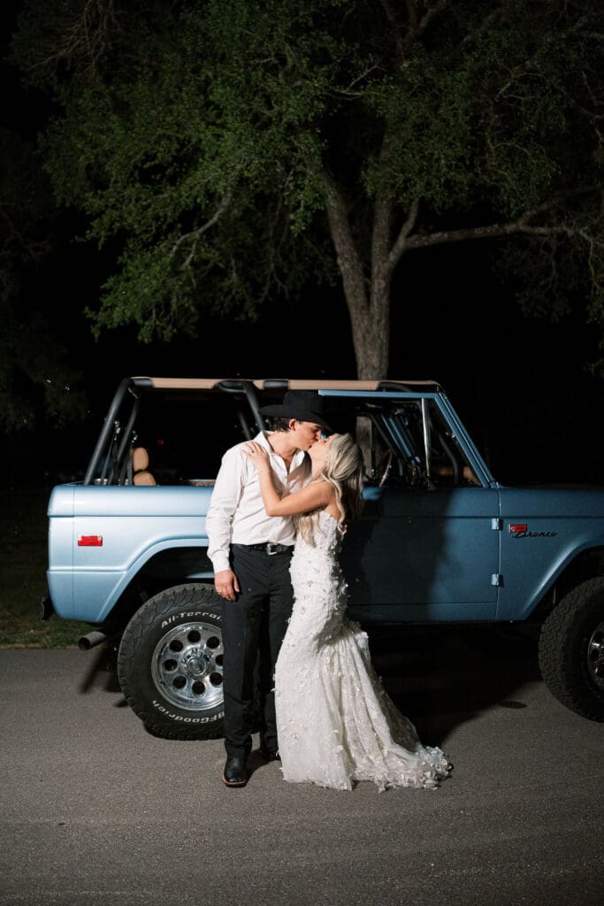 Bronco exit car with bride and groom at Dos Palomas Ranch wedding photographed by Diana Brewer