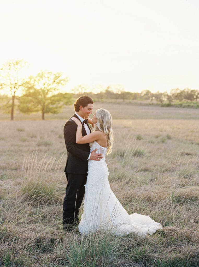 Bride and groom embracing at sunset at Dos Palomas Ranch wedding