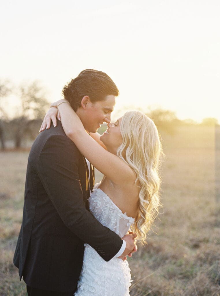 Bride and groom embracing at sunset at Dos Palomas Ranch wedding