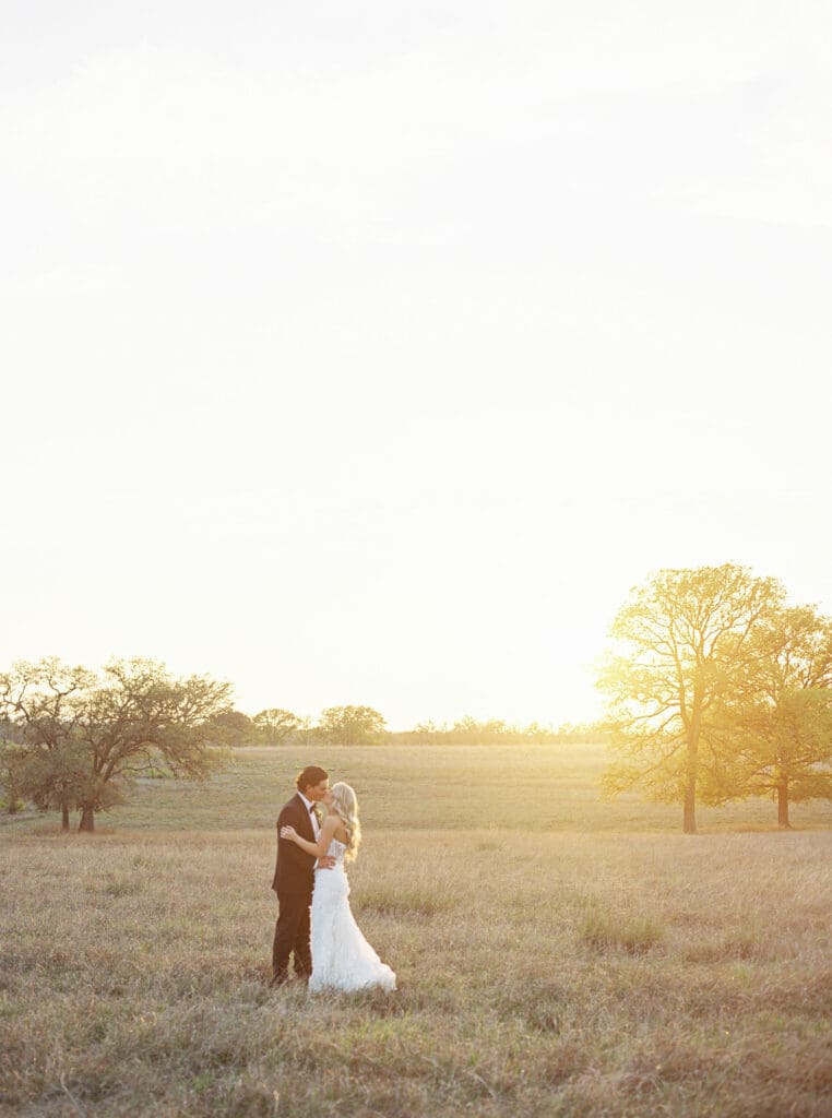 Bride and groom embracing at sunset at Dos Palomas Ranch wedding