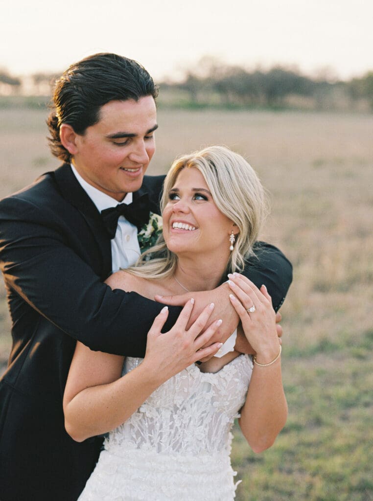 Bride and groom embracing at sunset at Dos Palomas Ranch wedding