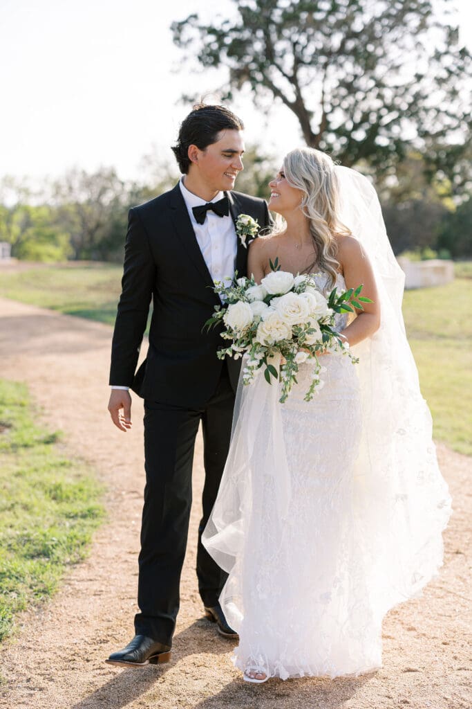 Bride and groom embracing at sunset at Dos Palomas Ranch wedding