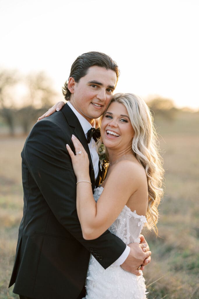 Bride and groom embracing at sunset at Dos Palomas Ranch wedding