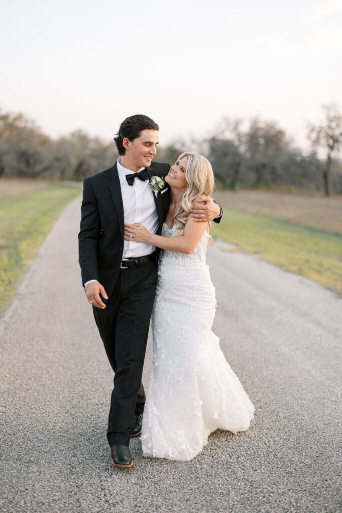 Bride and groom embracing at sunset at Dos Palomas Ranch wedding