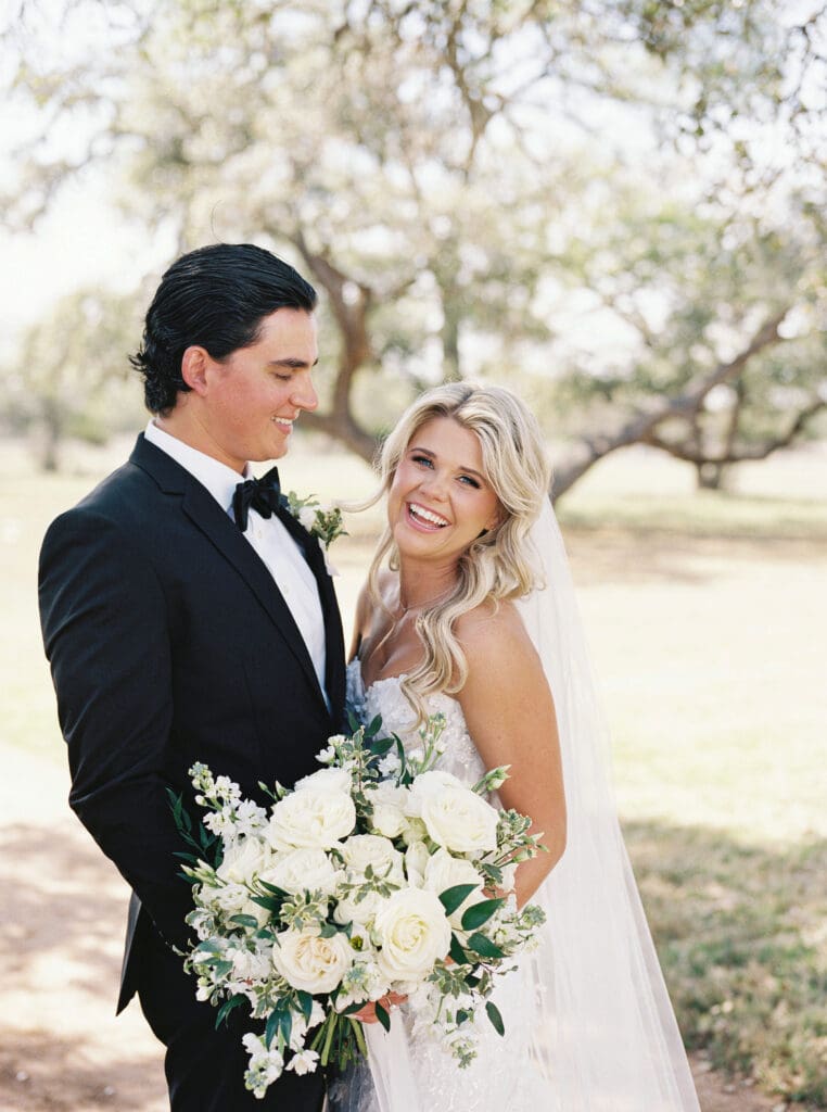 Candid laughter during bride and groom portraits at Dos Palomas Ranch