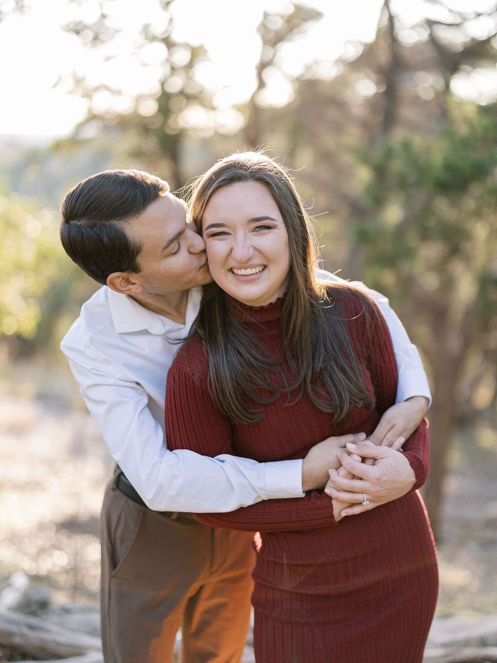 Couple embracing at family home during Wimberley engagement session