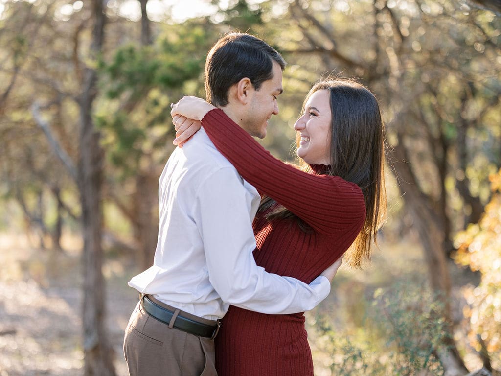 Couple embracing at family home during Wimberley engagement session
