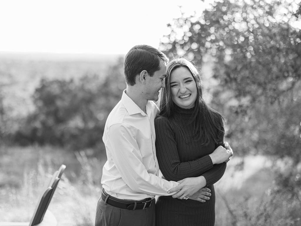 Couple embracing at family home during Wimberley engagement session