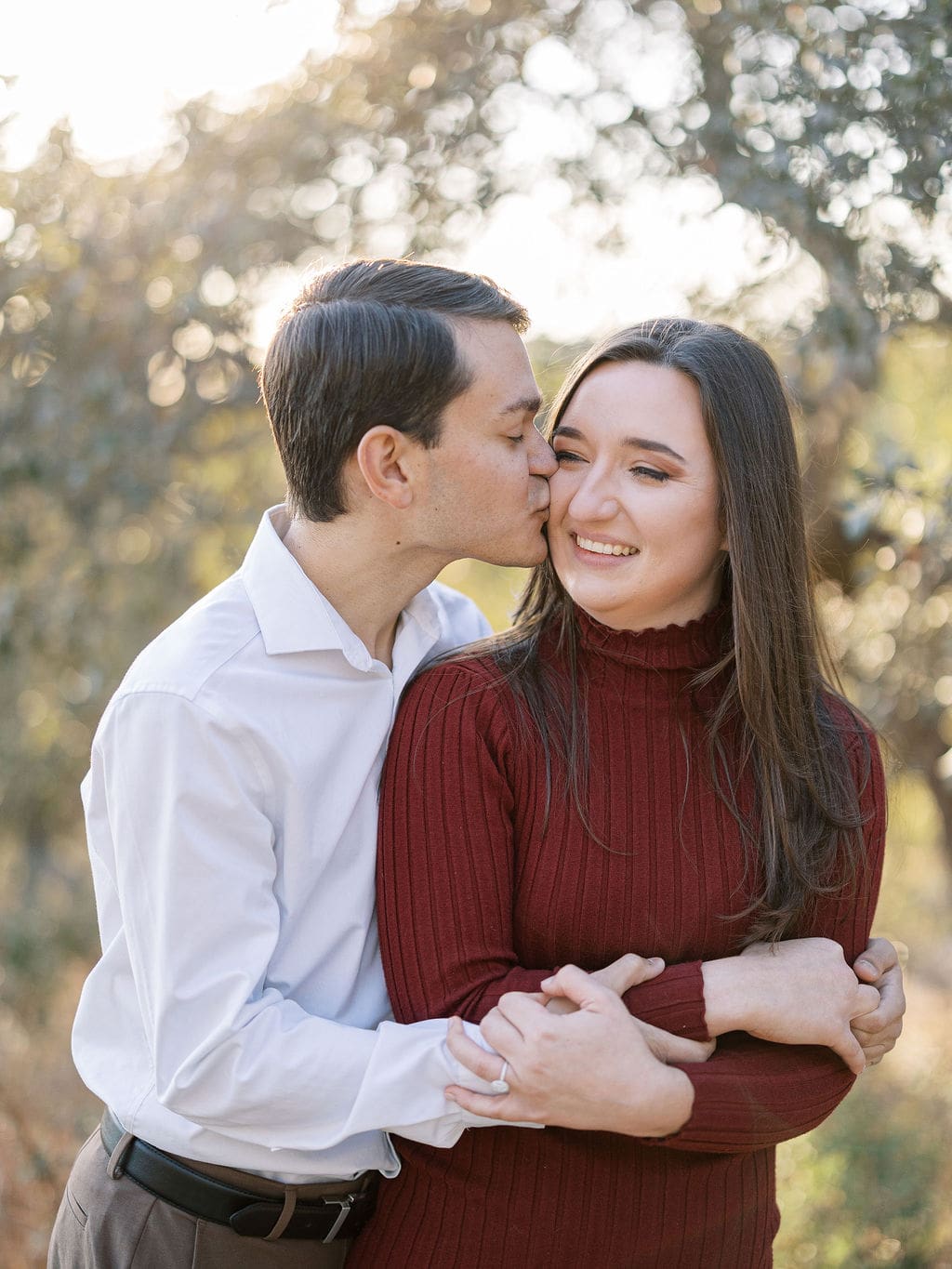 Couple embracing at family home during Wimberley engagement session