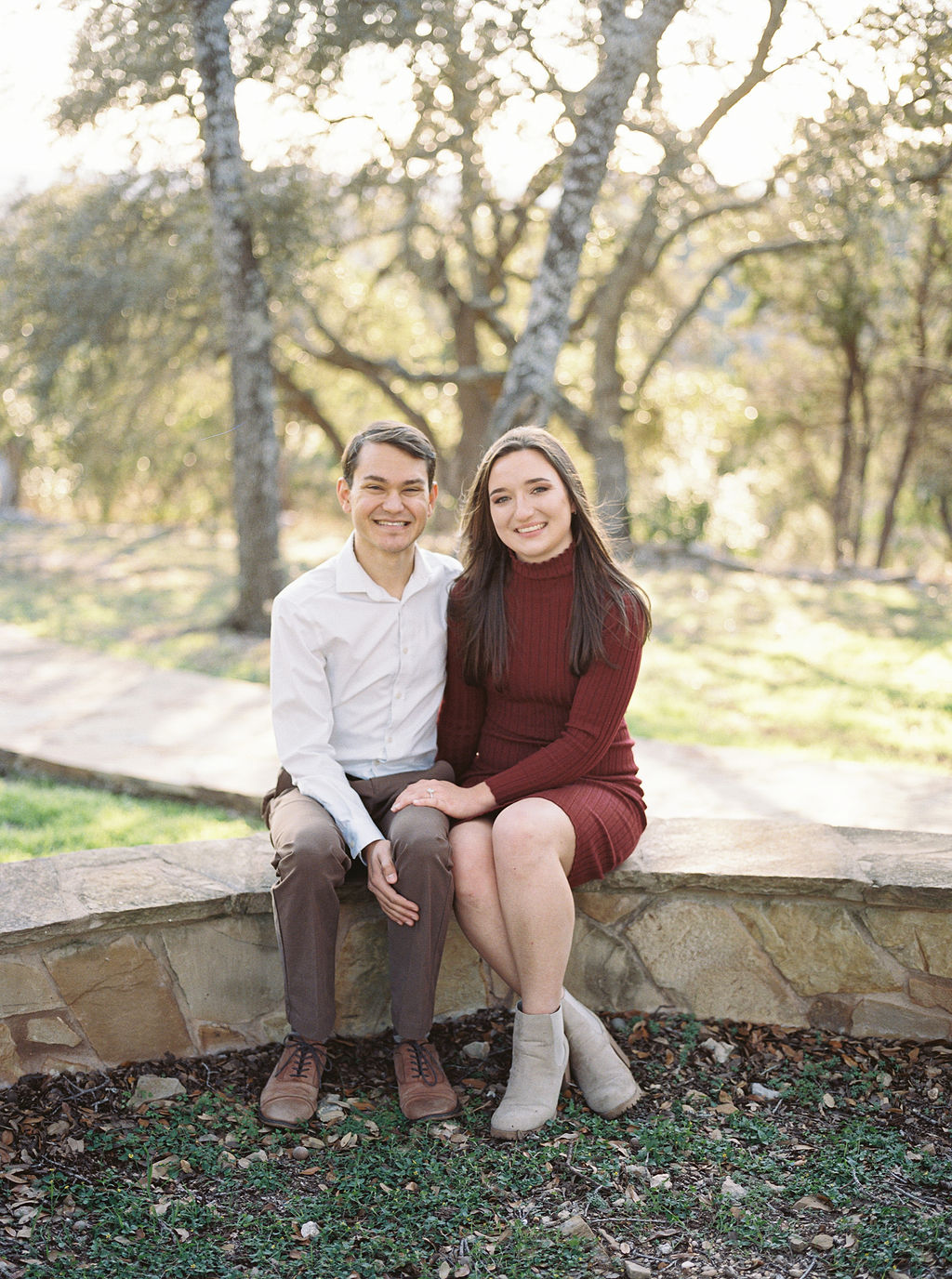 Couple laughing during engagement session at Wimberley winter home