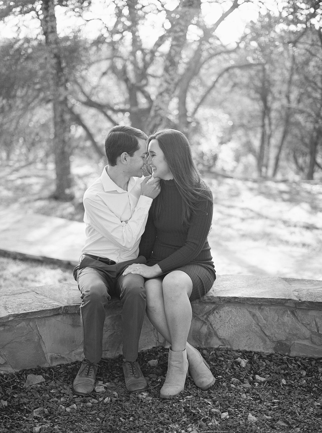 Couple laughing during engagement session at Wimberley winter home