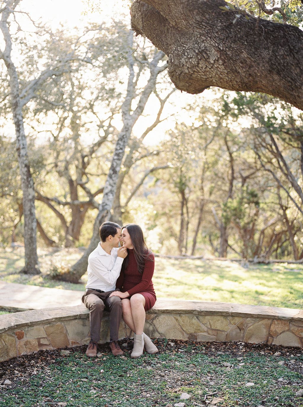 Couple laughing during engagement session at Wimberley winter home