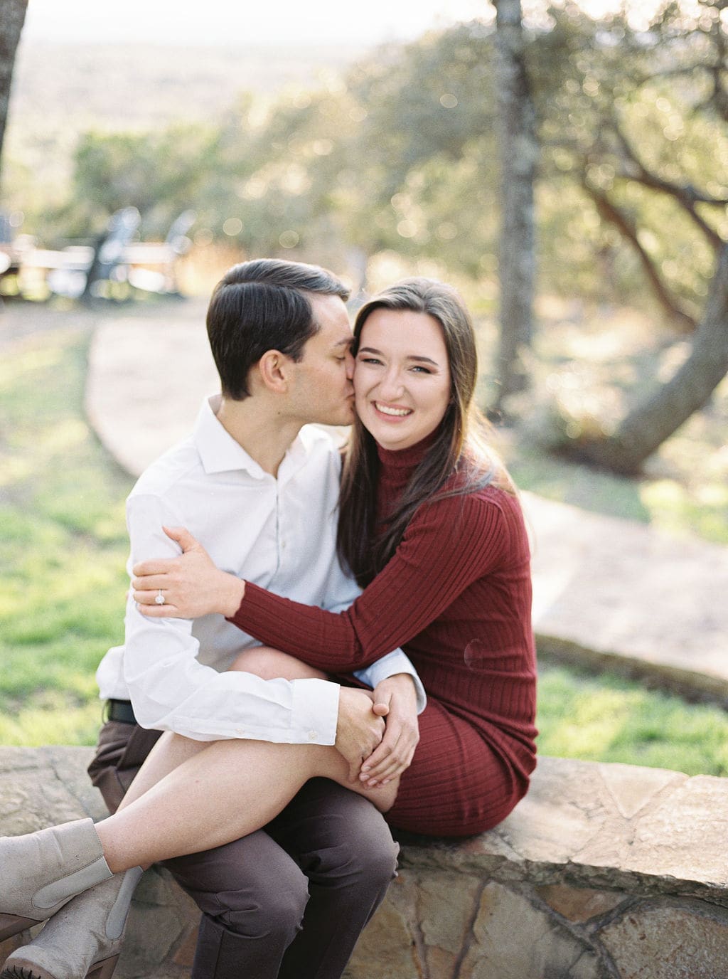 Couple laughing during engagement session at Wimberley winter home