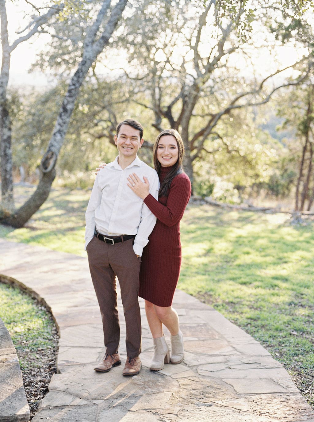 Couple laughing during engagement session at Wimberley winter home