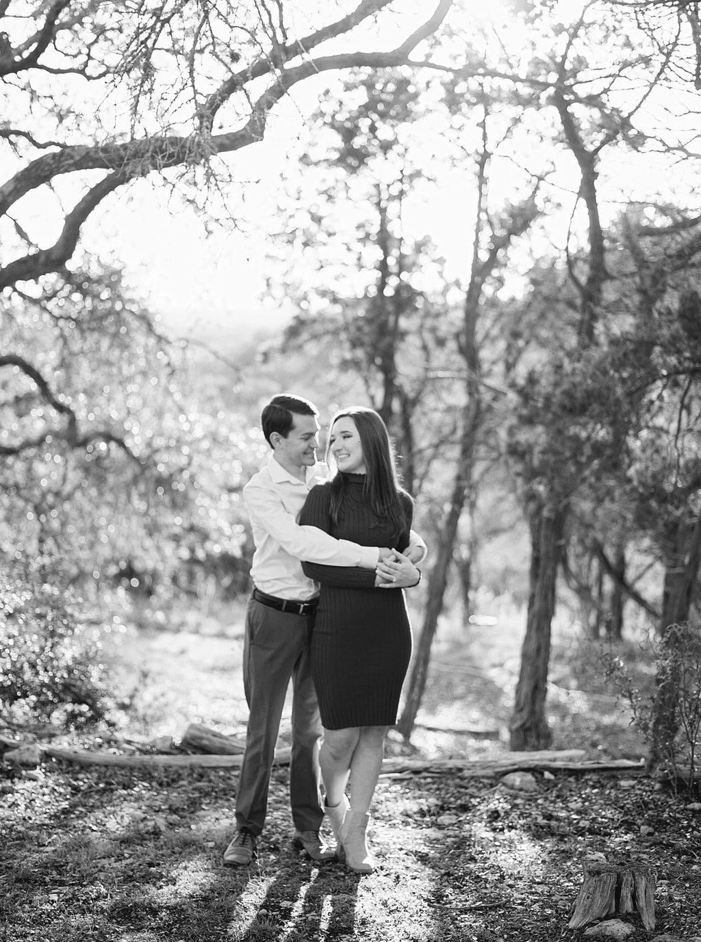 Couple laughing during engagement session at Wimberley winter home