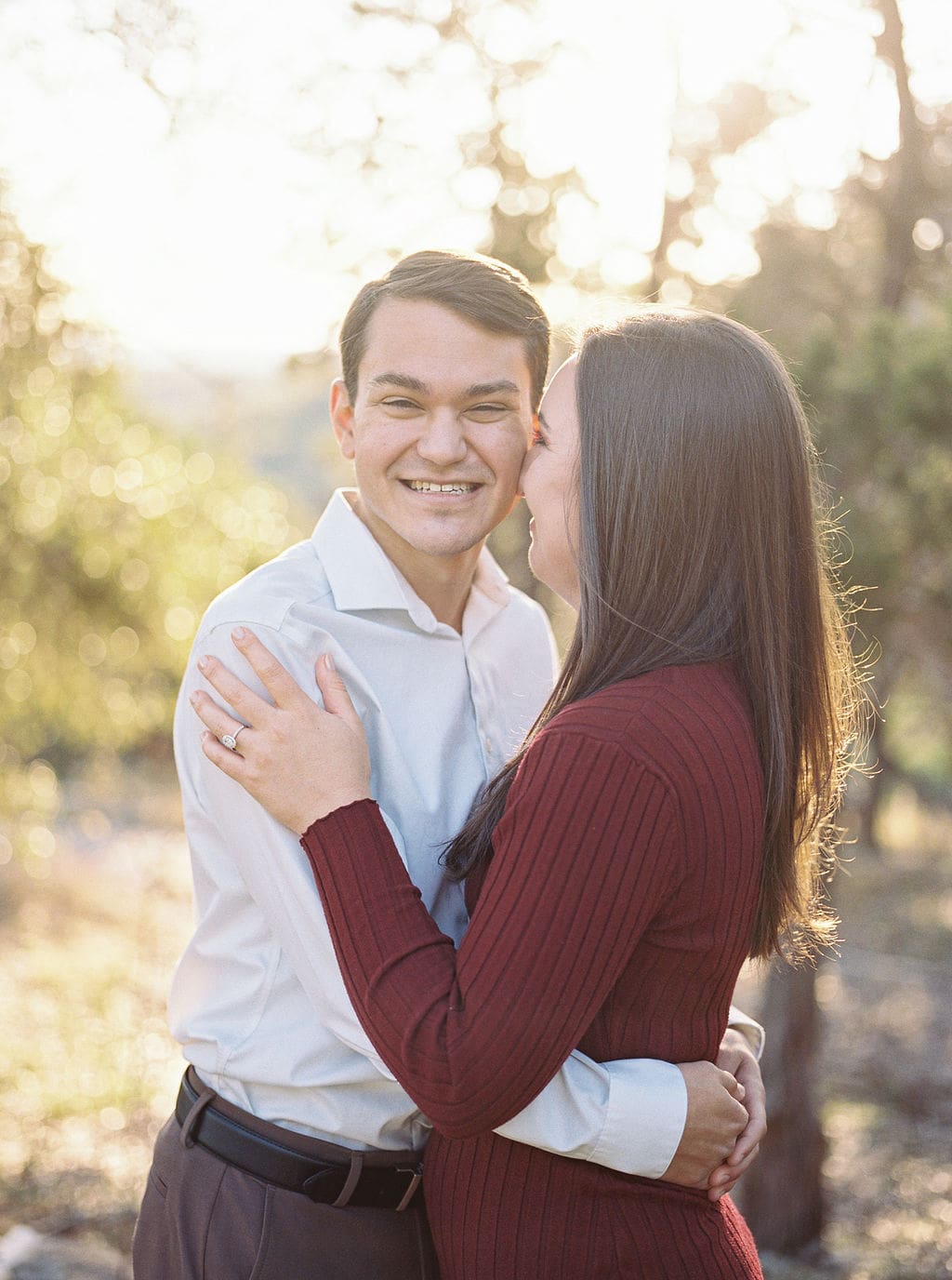 Couple laughing during engagement session at Wimberley winter home