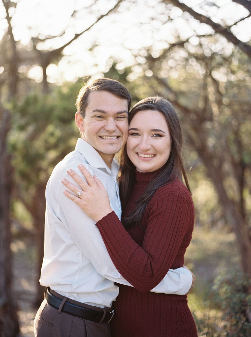 Couple laughing during engagement session at Wimberley winter home